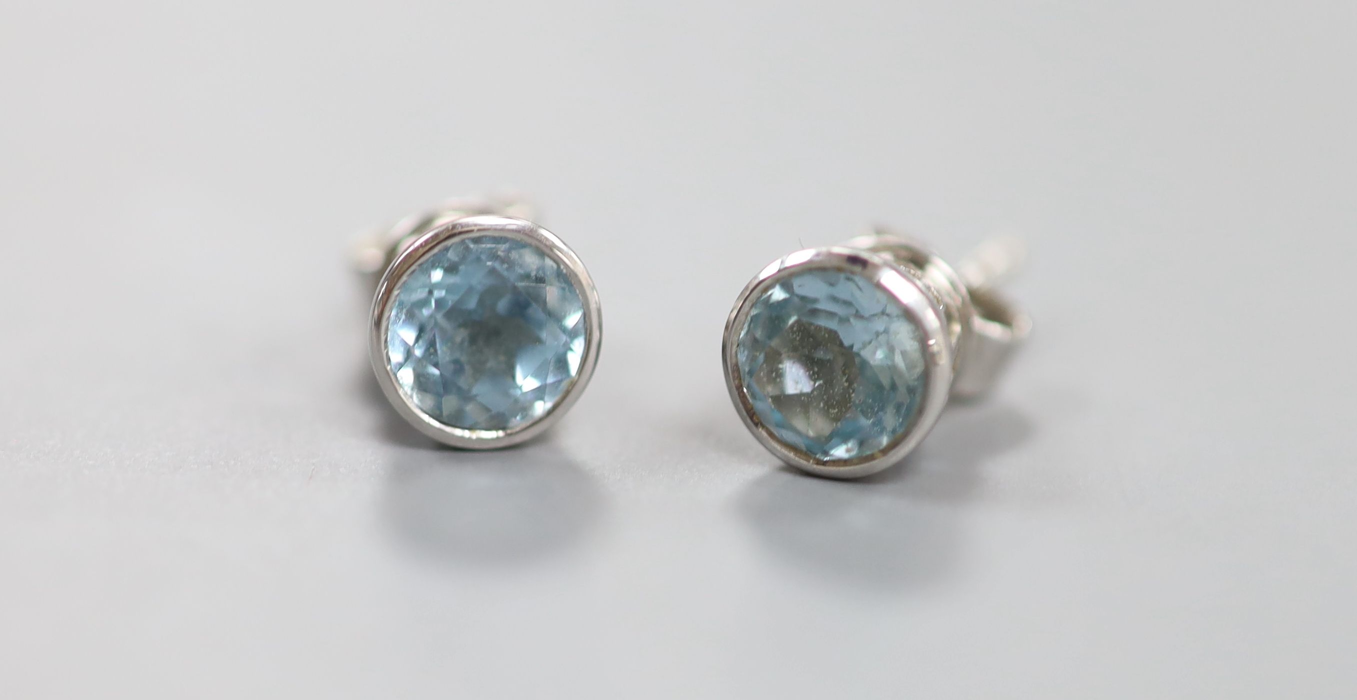 A cased modern pair of Theo Fennell 18ct white gold and blue topaz set ear studs